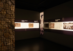 Interior of the gallery room with exhibits and photographs on display.