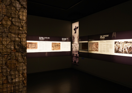 Interior of the gallery room with exhibits and photographs on display.