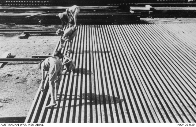 Prisoners of war laying rails in rows for railway construction