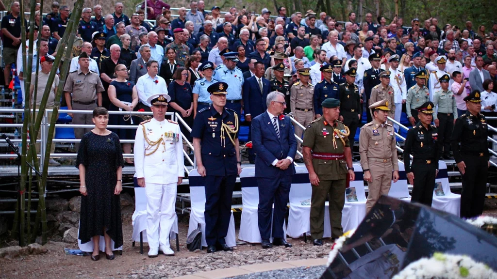 Group of people many in uniform standing for an event.