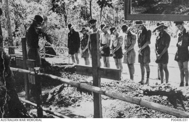 A group of men in attendance of a prisoner of war funeral.